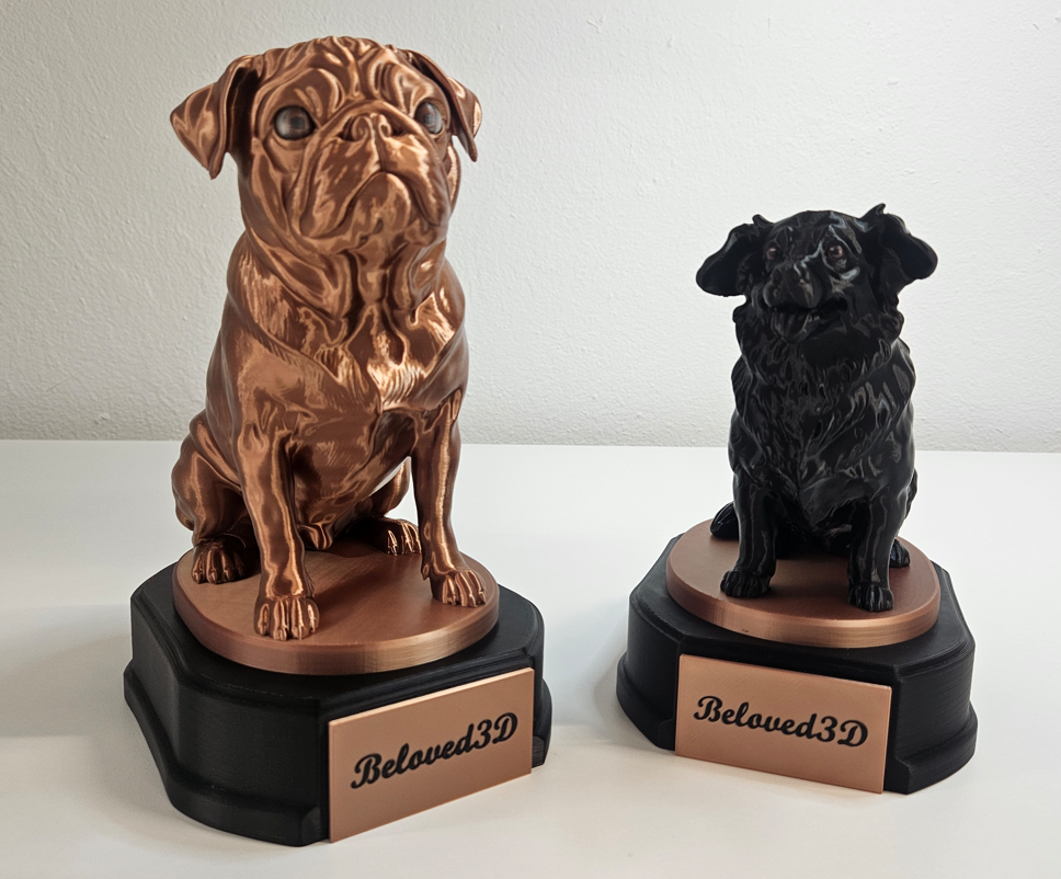 Two pet statuettes showing different copper and black color finishes